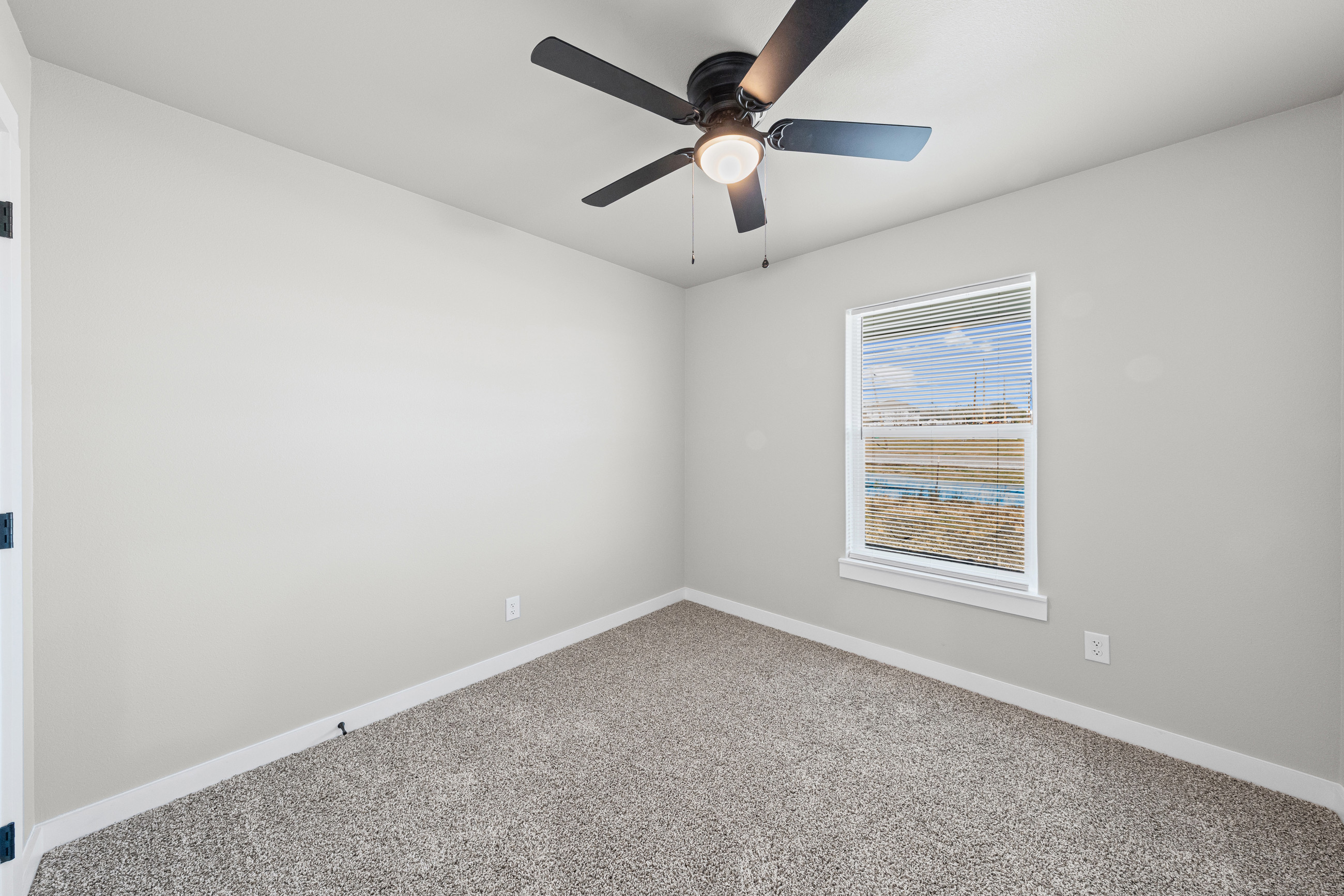 Spacious bedroom with ceiling fan
